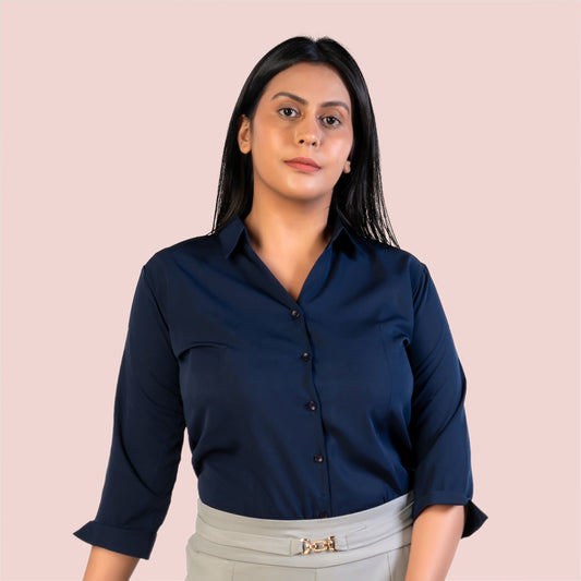 Woman wearing a navy blue shirt against a pink background